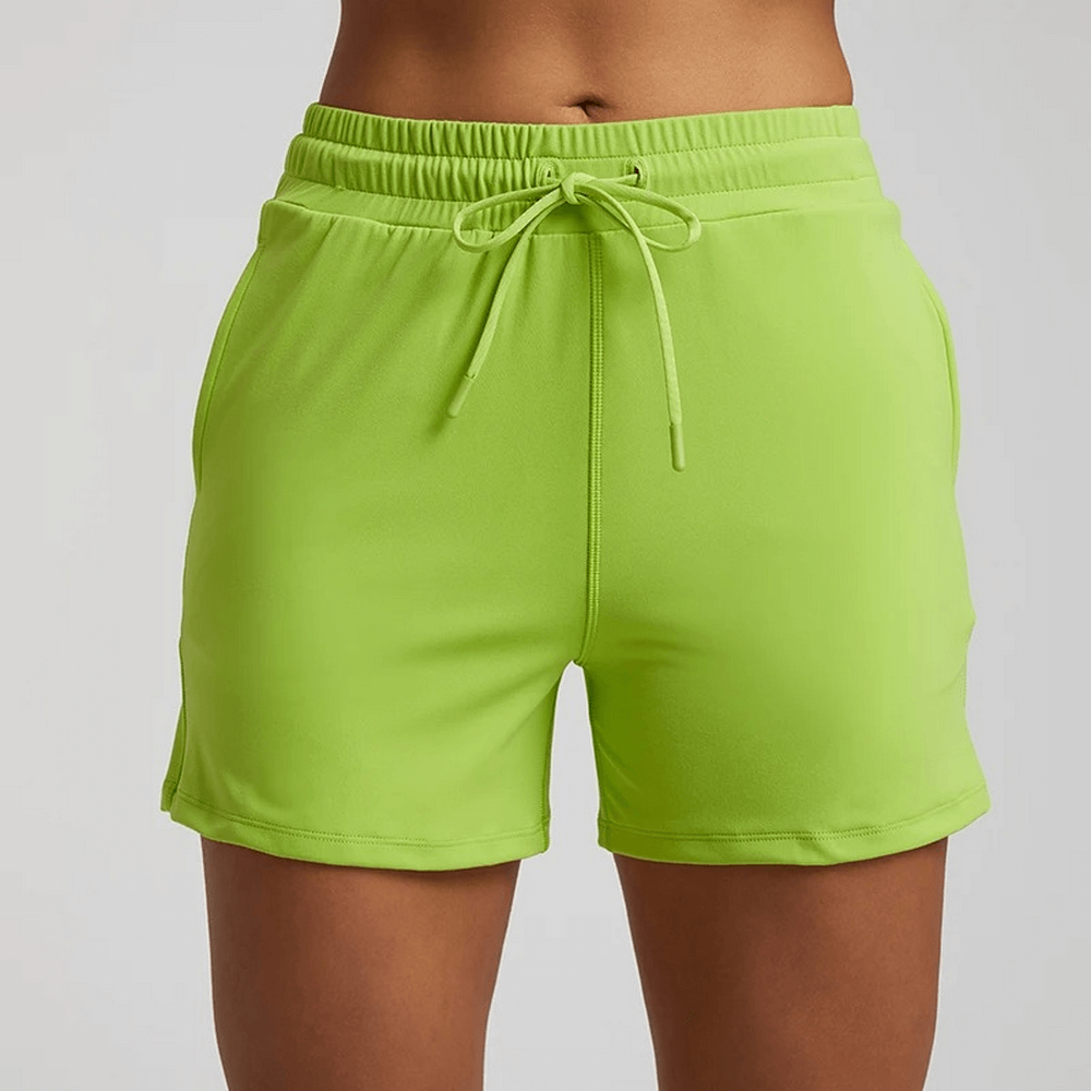 Women's neon green workout shorts with elastic waistband, ideal for gym or casual wear. Made from durable nylon and spandex blend.